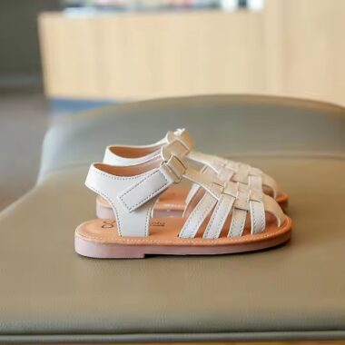 Flat fashion kids sandals in solid colors with adjustable straps, perfect for summer wear.